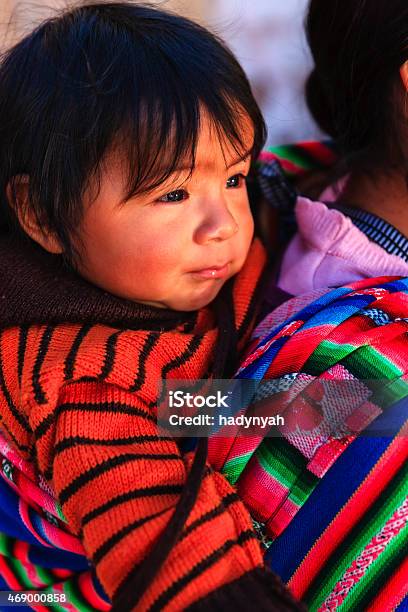 Peruvian Woman With Her Baby On The Back Pisac Stock Photo - Download Image Now - 2015, Adult, Altiplano