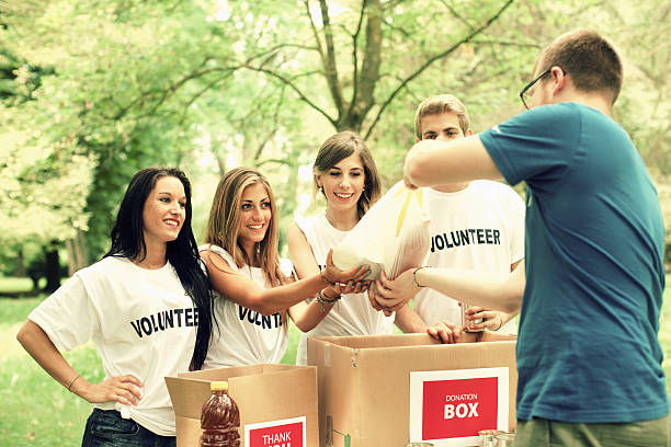 istock Young volunteers accepting food donations 469000918