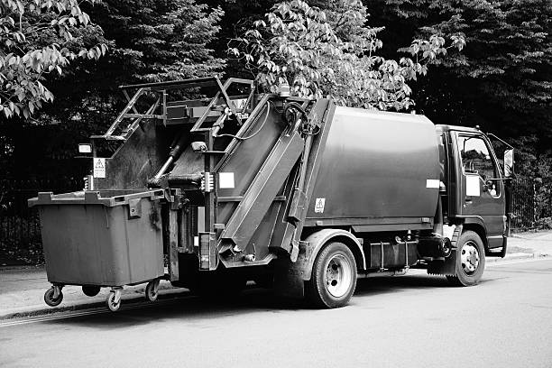 istock Garbage truck vehicle with an elevated blue wheelie bin 469001140