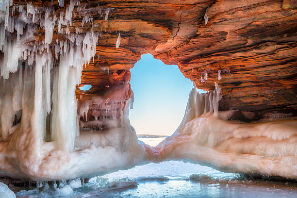 Ice Arch A beautiful natural arch on Lake Superior covered in ice brightly lit winter season rock stock pictures, royalty-free photos & images