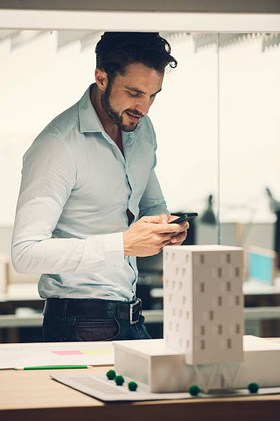 istock Designer typing on smart phone in office. 469002130