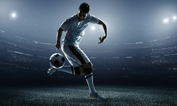 サッカー選手ボールを蹴るスタジアム - soccer player men flying kicking ストックフォトと画像