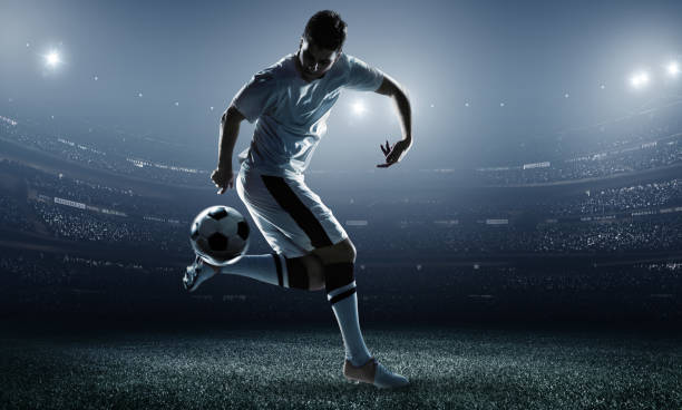 istock Soccer player kicking ball in stadium 469002484