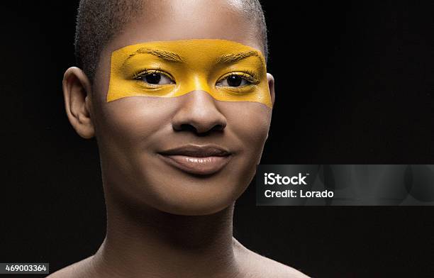 Black Woman With Yellow Line Makeup On Her Face Stock Photo