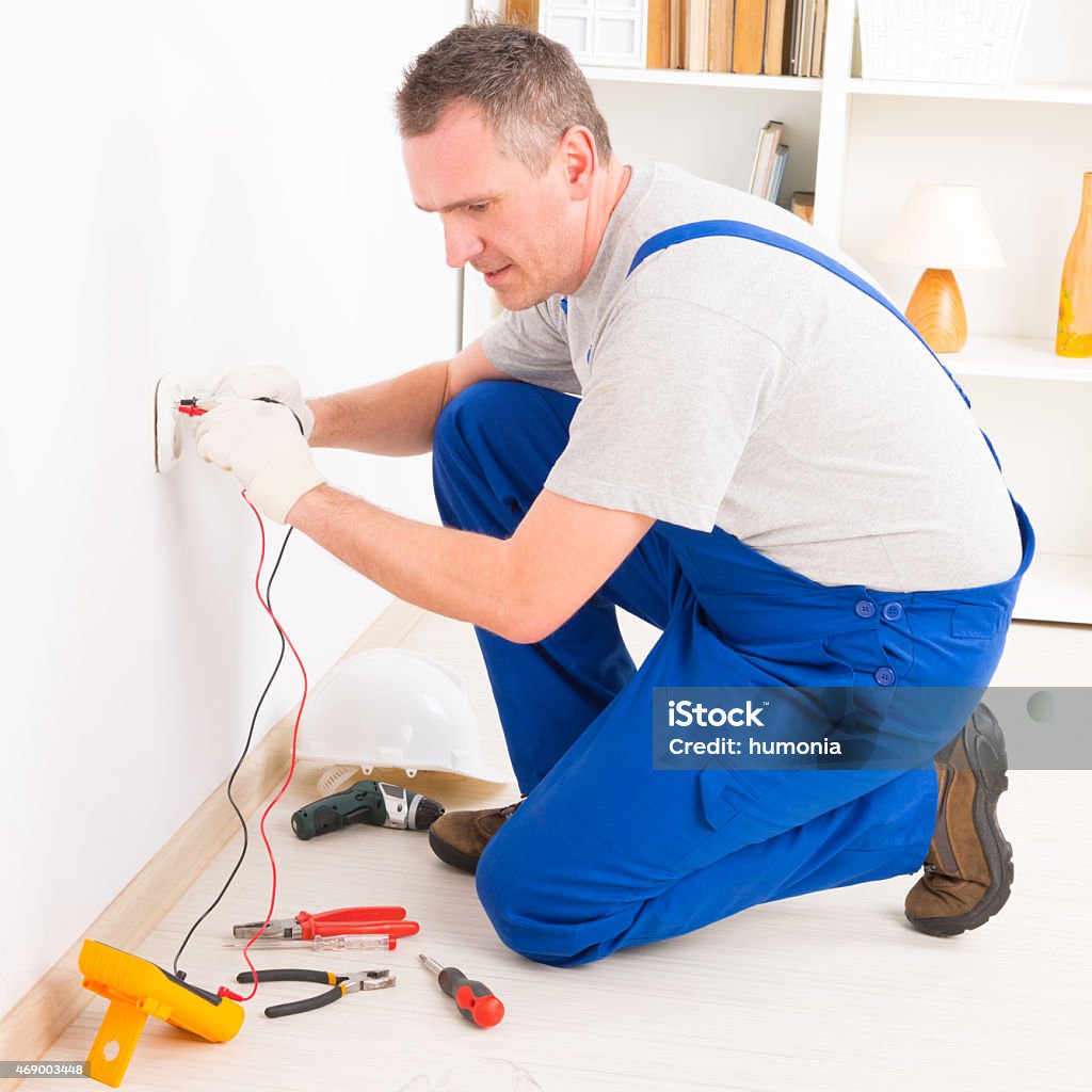 Person Checking Plug Socket Man In Blue Overalls Checking Electrical Socket Stock Photo - Download ...