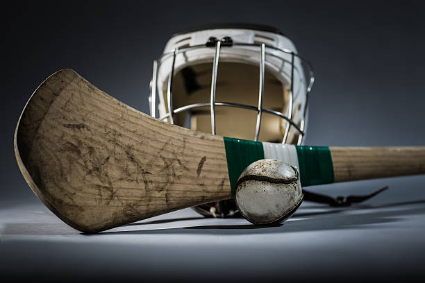 Hurling Equipment in Studio a studio shot of a hurling stick, ball, and helmet. face guard sport stock pictures, royalty-free photos & images