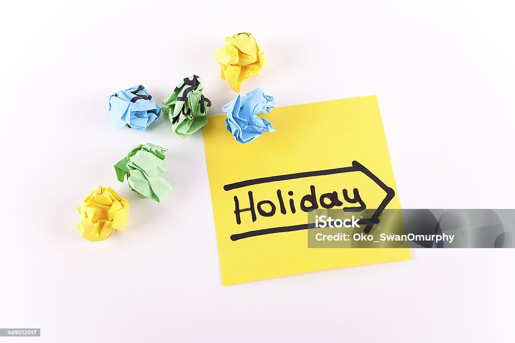 Holiday Holiday note with arrow on sticky yellow note, white background Adhesive Note Stock Photo