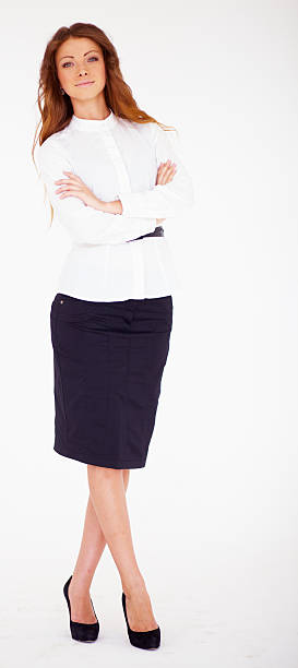 istock Confident young business lady standing with folded hand 469018273