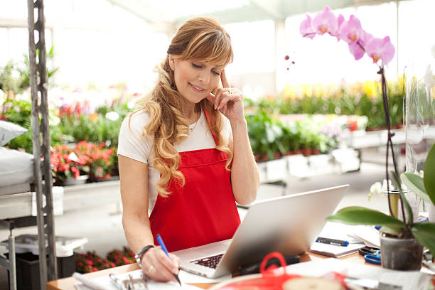 istock Sales clerk working numbers at a garden center 469019370