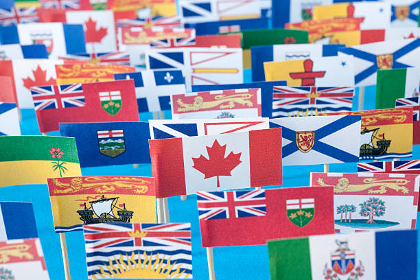 Canadian provinces and territories flags Paper made flag of canadian provinces and territories over blue background newfoundland and labrador photos stock pictures, royalty-free photos & images