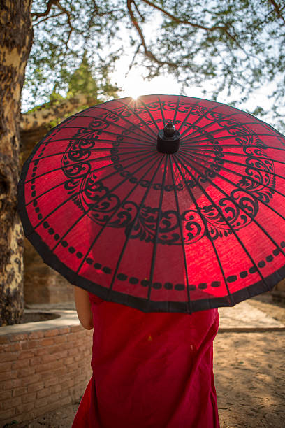 istock Young Monk with red Umbrella at Bagan Temples, Myanmar. 469024654