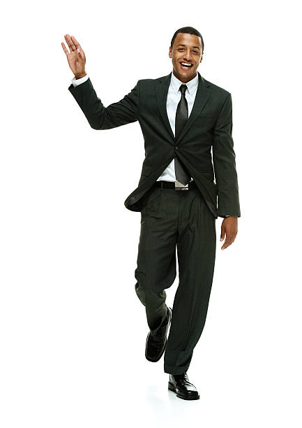 istock Cheerful businessman walking and waving hand 469025350