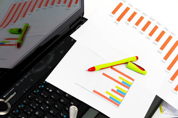 istock Analyzing business investment charts with calculator and laptop 469025868