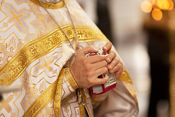 istock hands holding Gospel in church 469026422