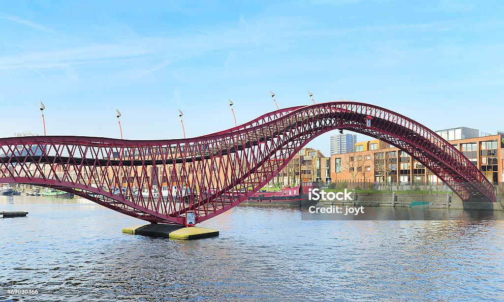 Python bridge The modern red Python bridge in Amsterdam, Netherlands. 2015 Stock Photo