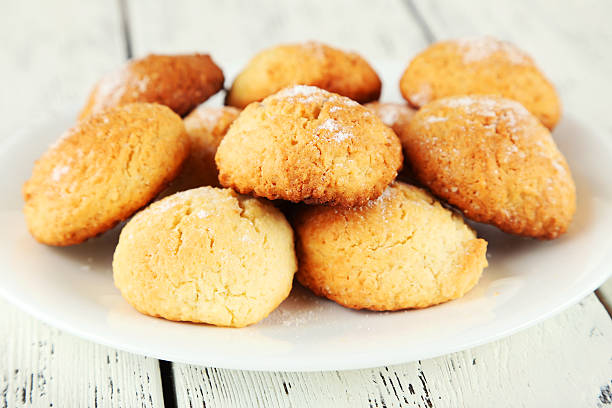 istock Coconut cookies on plate on white wooden background 469030670