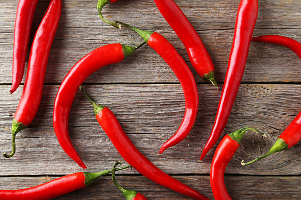 istock Red chili pepper on grey wooden background 469031148