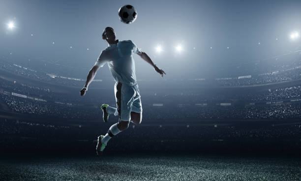 istock Soccer player kicking ball in stadium 469031416