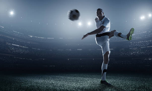 istock Soccer player kicking ball in stadium 469031430