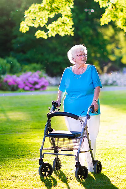istock Senior lady with a walking aid in the park 469033010