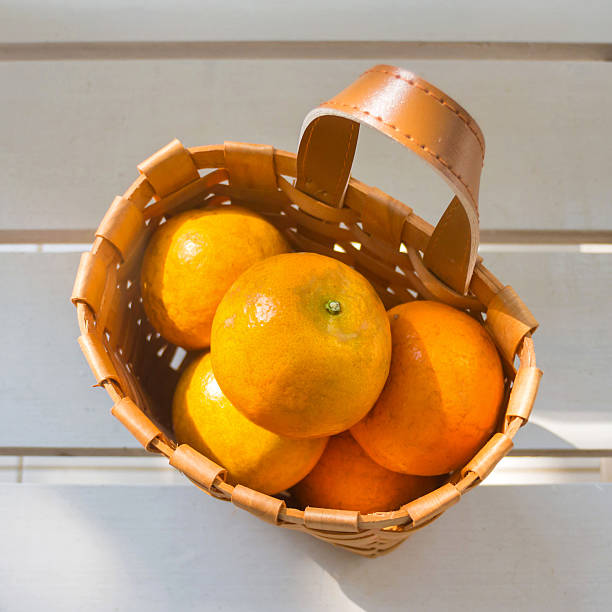 istock Oranges in the basket on white chair. 469033353