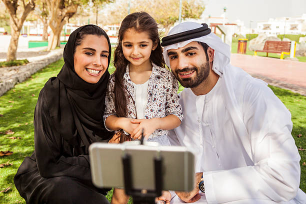 istock Traditional Emirati young family taking a selfie 469037130