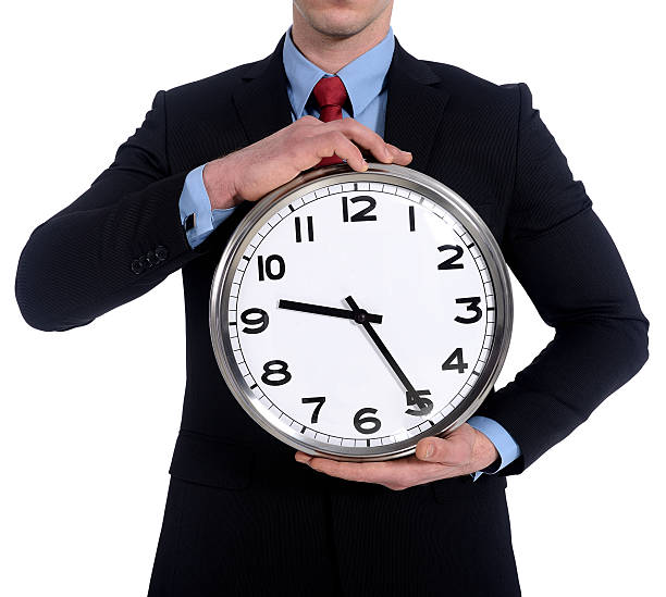 istock Young businessman holding a clock 469037415