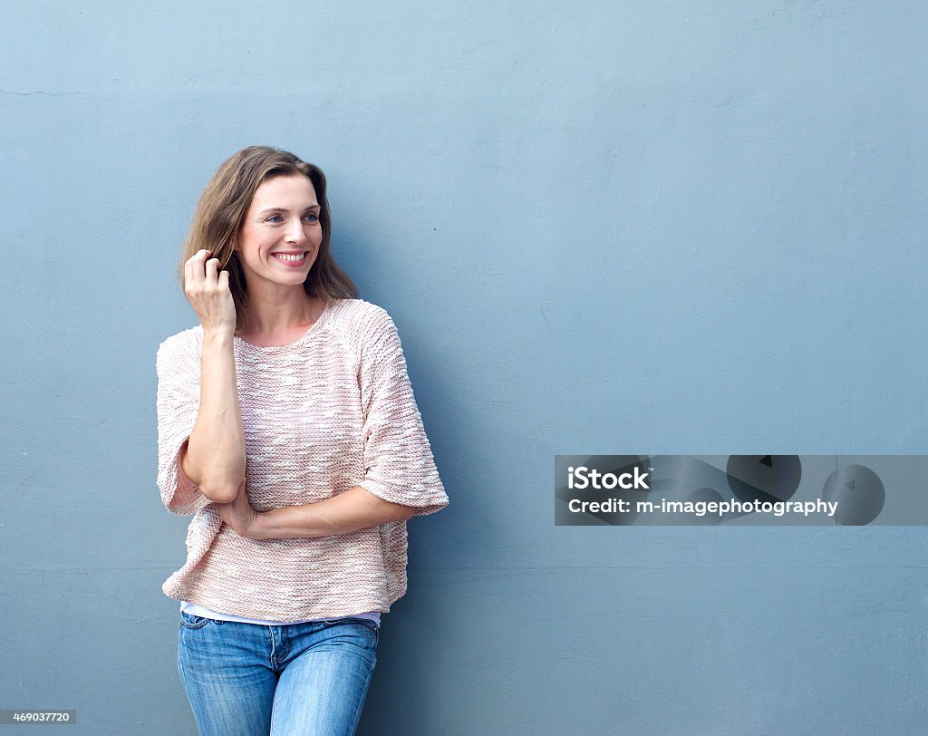 Attractive mid adult woman smiling with hand in hair Portrait of an attractive mid adult woman smiling with hand in hair Women Stock Photo