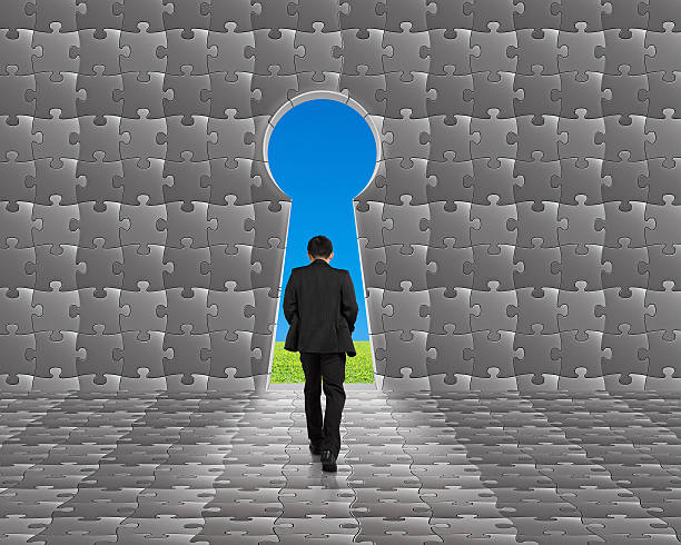 istock Businessman walking toward key shape door on puzzles wall 469038451