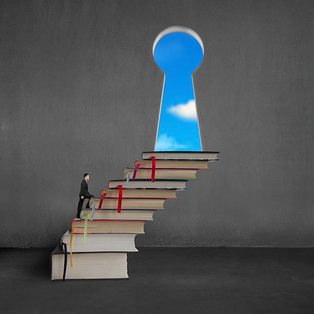 istock Businessman climbing on stack books to key shape door 469041891