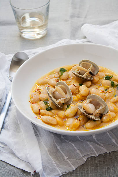 Fabes with clams Fabe beans with clams. Traditional Spanish food from Asturias. fabes stock pictures, royalty-free photos & images