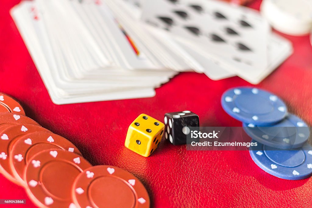 Gambling Background Dice Rolling the dice in crowded gambling themed background, red for warning of addiction 2015 Stock Photo