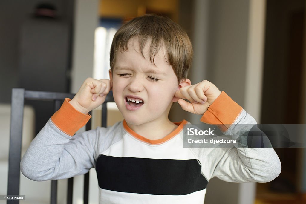 4 year old boy  clog his ears with fingers 4 year old boy screaming and clog his ears with fingers at home Ear Stock Photo