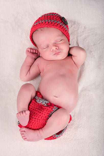 istock Newborn baby sleeping on his back. 469044066