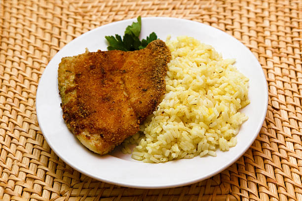 fried breaded tilapia served with rice stock photo