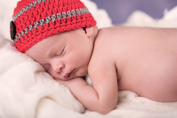 istock Newborn baby sleeping on a white blanket. 469045420