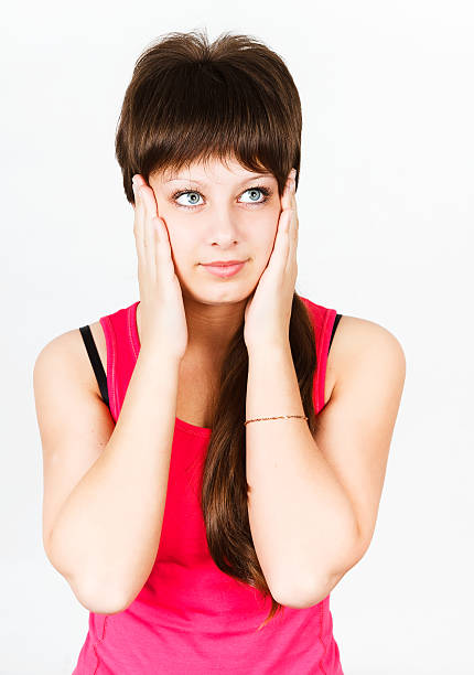 Headache. girl holding her head in her hands stock photo