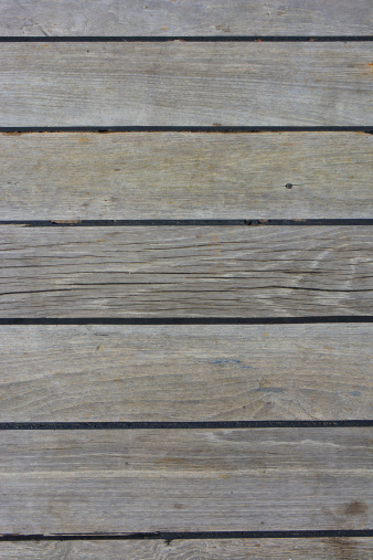 A boat deck's old grunge weathered and faded wood floor