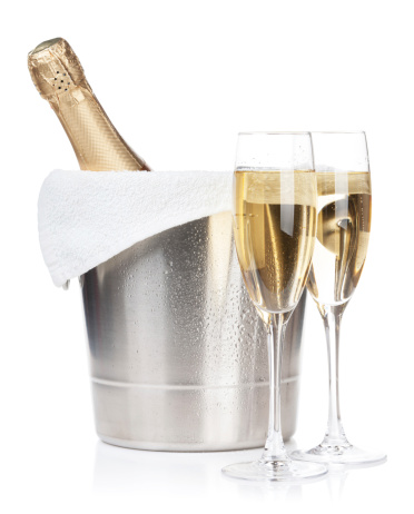 Champagne bottle in ice bucket and two glasses. Isolated on white background
