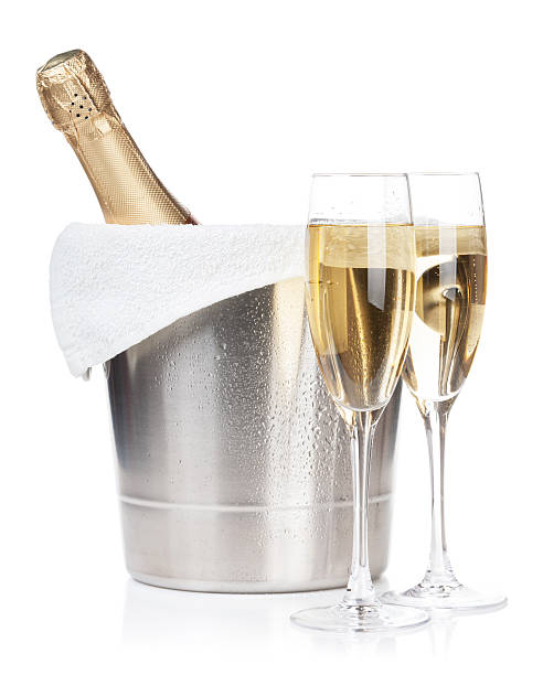 Champagne bottle and two glasses Champagne bottle in ice bucket and two glasses. Isolated on white background cooler container photos stock pictures, royalty-free photos & images