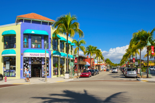 Fort Myers, USA - December 3, 2013: Pedestrians walking past colorful businesses on Old San Carlos Boulevard, in the central shopping and dining district of Fort Myers Beach, Florida.