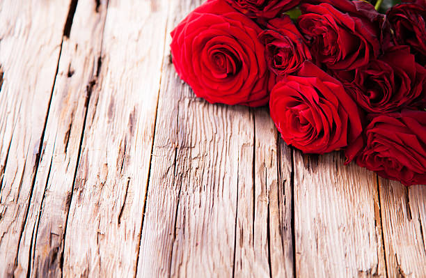 istock Red roses on wood 469049389