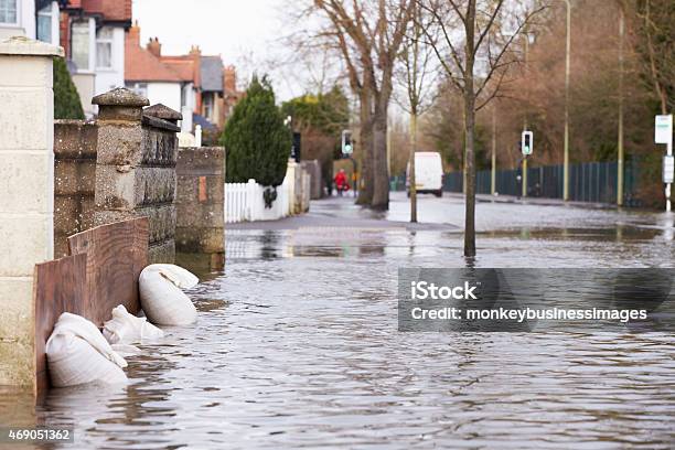 Sandbags Outside House On Flooded Road Stock Photo - Download Image Now - Flood, Climate Change, City