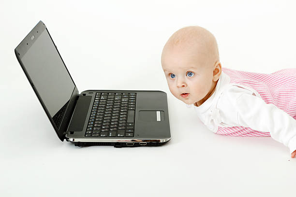 baby with laptop stock photo