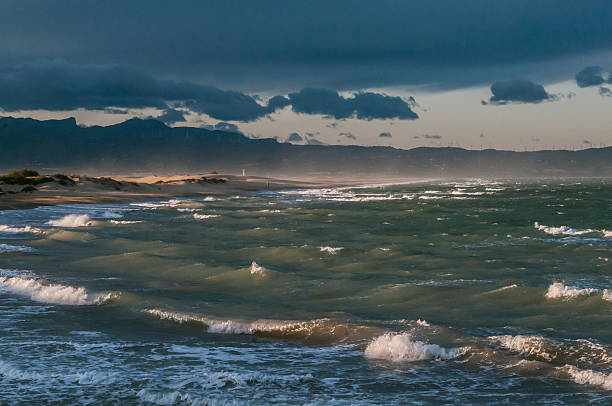 late afternoon The last rays of the sun illuminate the rough sea by the wind, in the delta of the Ebro river tarde stock pictures, royalty-free photos & images