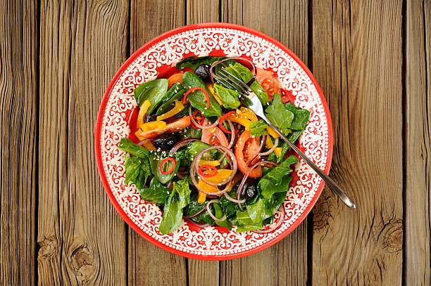 istock Spring salad with vegetables: spinach, tomatoes, olives, onion, 469052212
