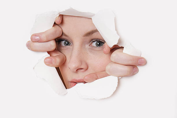 istock young woman peeking 469052518