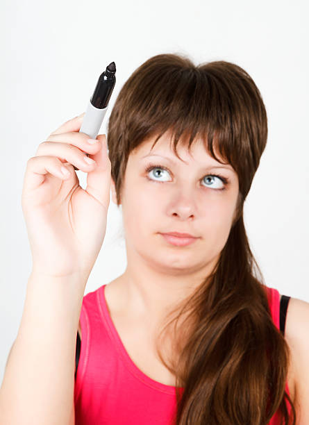istock Young girl writing with a black marker 469056402