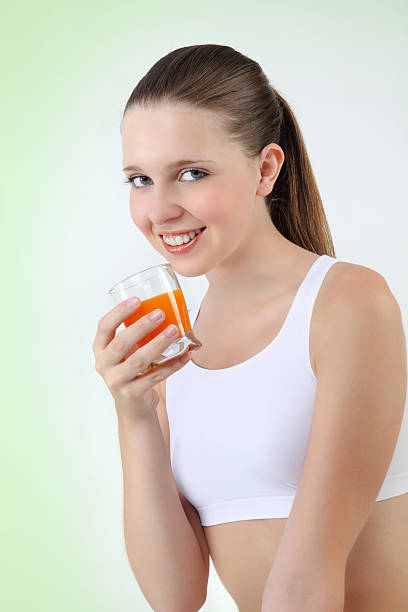 istock smiling woman drinking orange juice vitamin 469056807