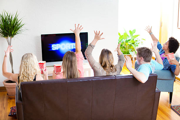 istock Youth Watching TV Sport Program on Television Broadcasting 469057098